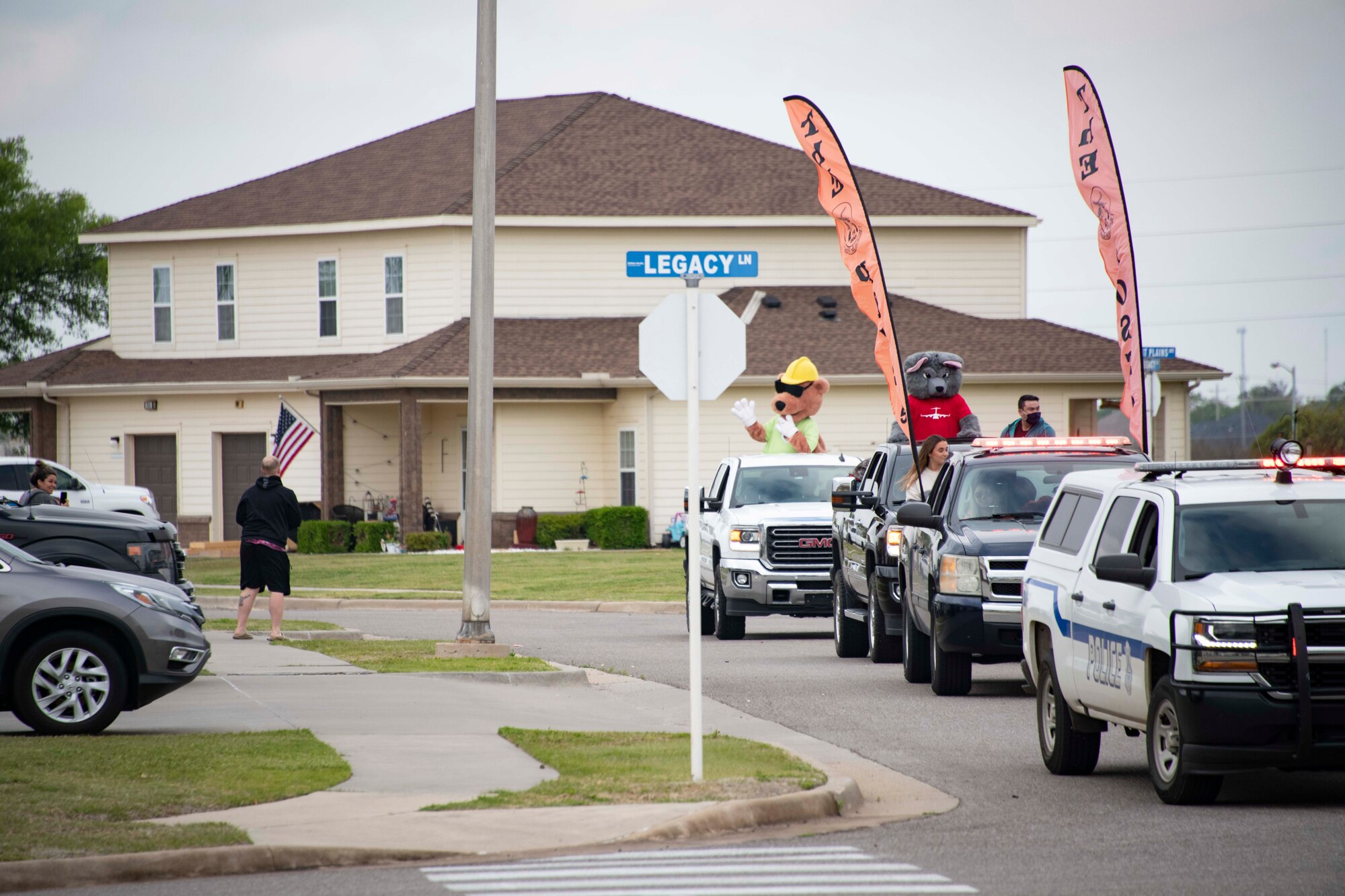 people wave at a parade
