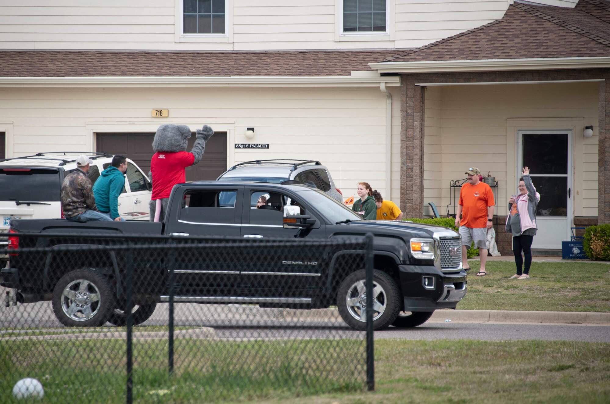 people wave at a parade