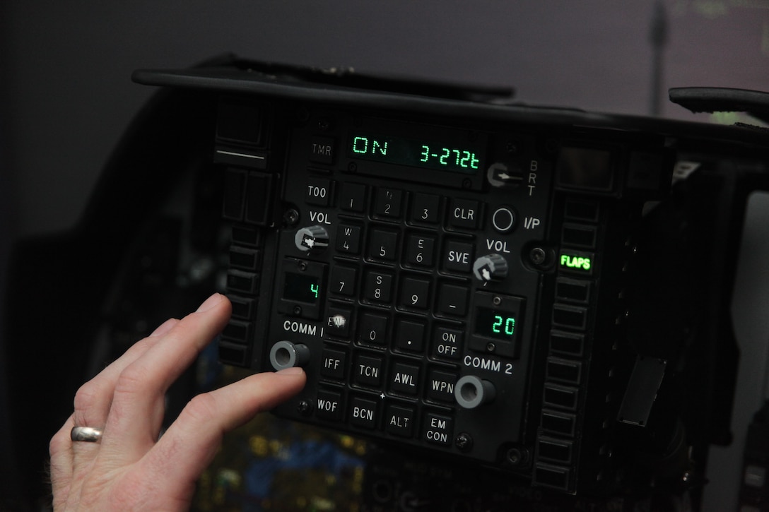 1st Lt. Matthew C. Forman, a replacement pilot with VMAT-203, types in command codes during preflight checks in an AV-8B Harrier simulator March 11. Over the next few weeks, the students will work on perfecting basic skills, testing their knowledge and make their first live flight with a pilot trainer in the TAV-8B Harrier, a two-seated training aircraft.