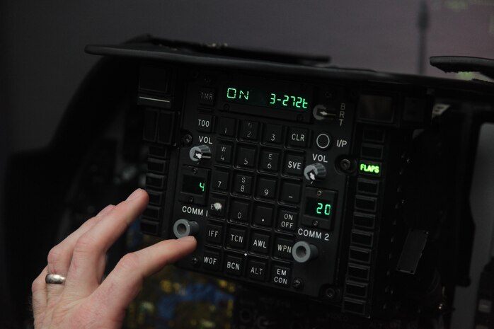 1st Lt. Matthew C. Forman, a replacement pilot with VMAT-203, types in command codes during preflight checks in an AV-8B Harrier simulator March 11. Over the next few weeks, the students will work on perfecting basic skills, testing their knowledge and make their first live flight with a pilot trainer in the TAV-8B Harrier, a two-seated training aircraft.