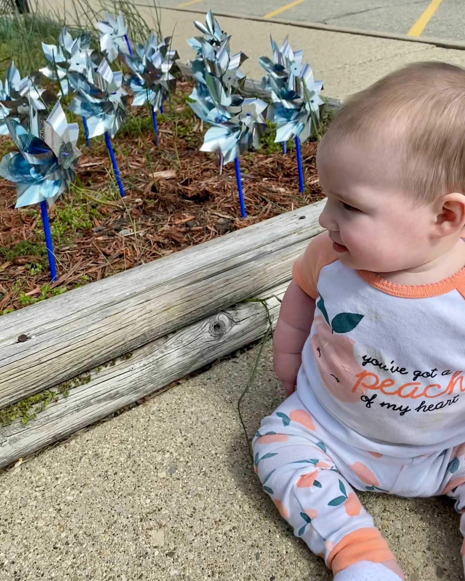 Georgia Rupert looks at the Pinwheel Garden planted in front of New Horizons Child Development Center on Wright- Patterson Air Force Base, Ohio April 23, 2021. Pinwheels for Prevention is a national campaign that’s goal is to bring awareness to child abuse.