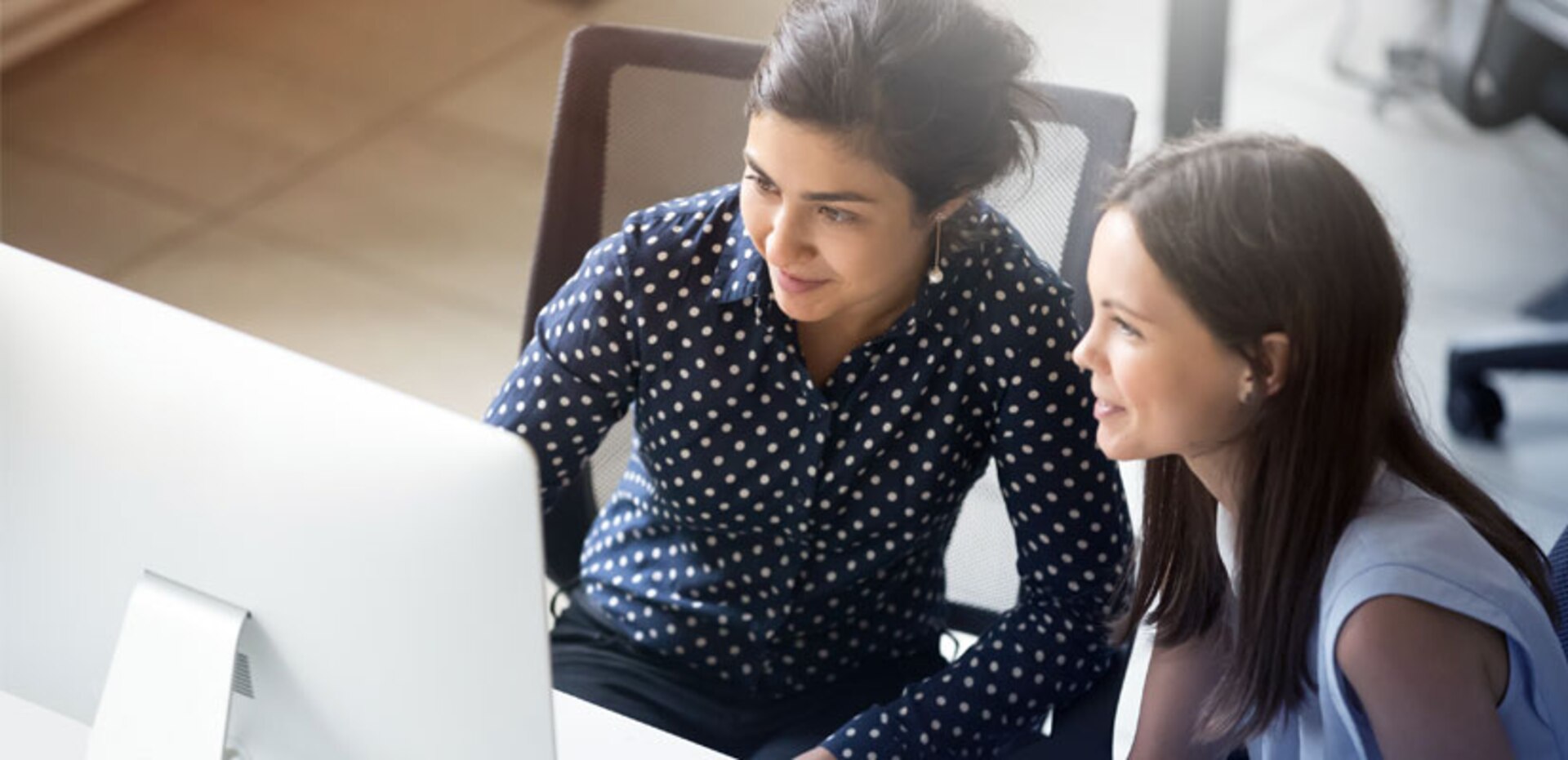 Two women looking at a computer