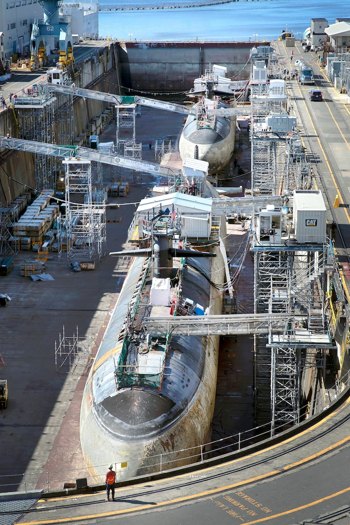 Los Angeles-class fast-attack submarines USS Louisville (SSN-724), foreground, and USS Olympia (SSN-717) began the inactivation process in Dry Dock 5 July 9, 2020 at Puget Sound Naval Shipyard & Intermediate Maintenance Facility in Bremerton, Washington. (PSNS & IMF photo by Scott Hansen)