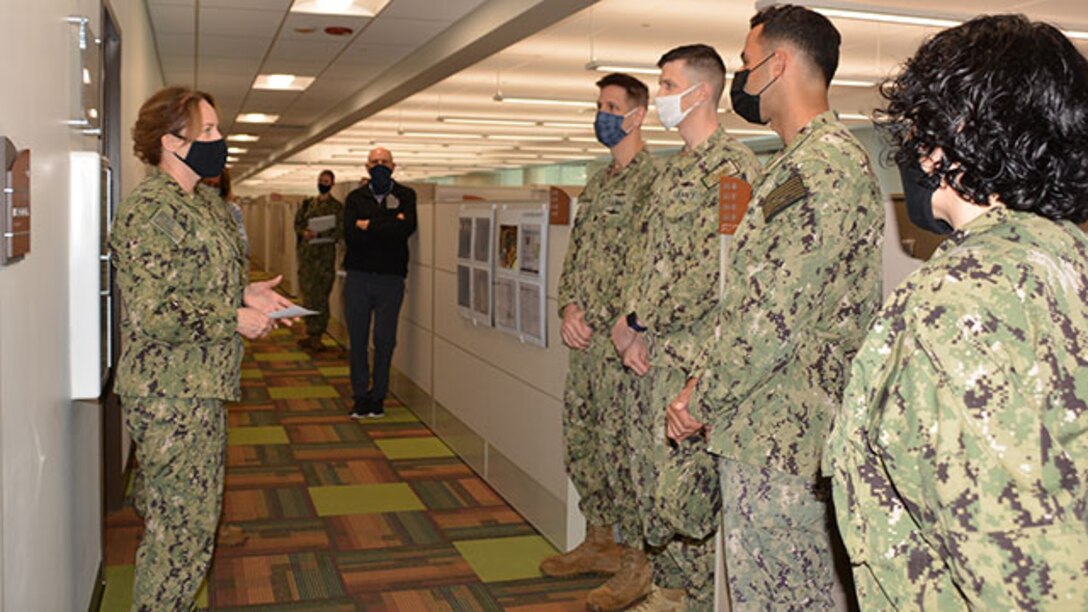 Admiral speaks with sailors.