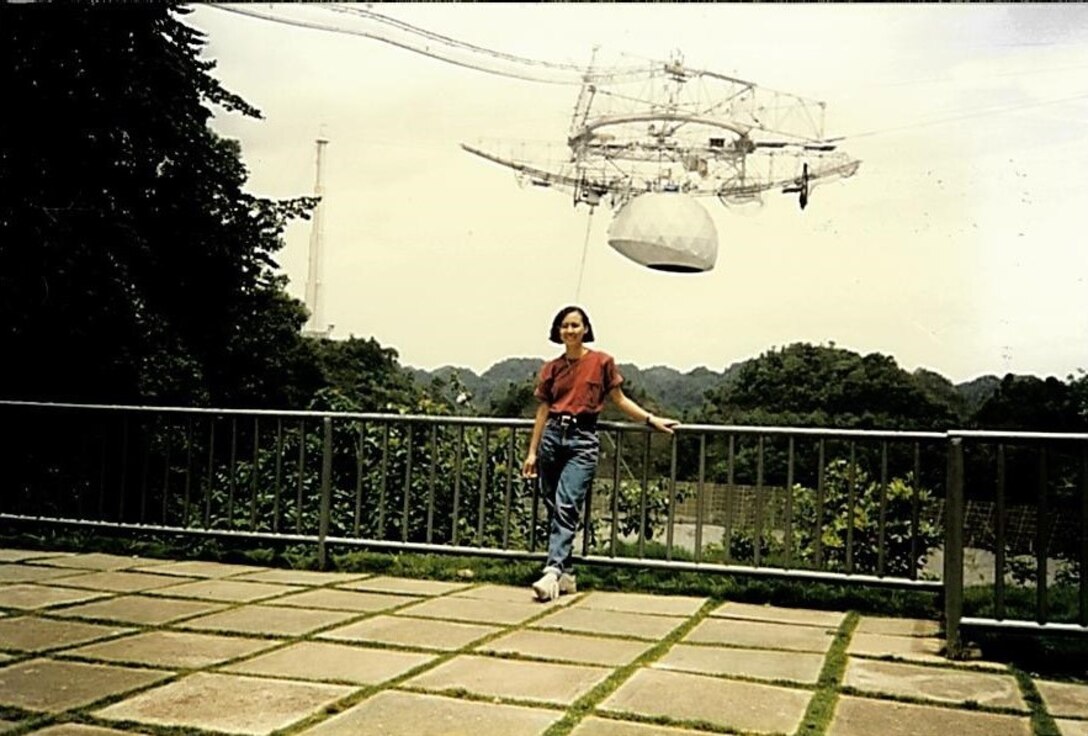 Lymari standing at the Arecibo Radio Telescope