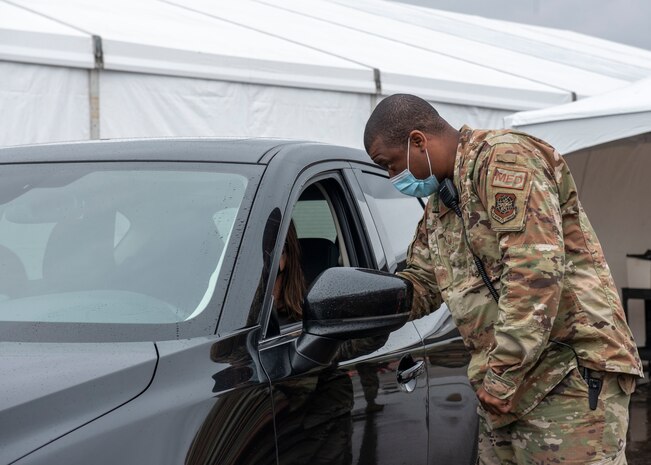 Master Sgt. Donald Ennis, Jr., assigned to the 628th Medical Group at Joint Base Charleston, South Carolina, directs a community member where to park after receiving the COVID-19 vaccine at the Community Vaccination Center (CVC) at the Minnesota State Fairgrounds in St. Paul, Minnesota, April 23, 2021. The CVC welcomes St. Paul community members to receive free COVID-19 vaccines. U.S. Northern Command, through U.S. Army North, remains committed to providing continued, flexible Department of Defense support to the Federal Emergency Management Agency as part of the whole-of-government response to COVID-19. (U.S. Air Force photo by Staff Sgt. Mikaley Kline)