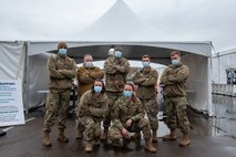 South Carolina, poses for a photo with his team at the American Disabilities Accessibility tent at the Community Vaccination Center (CVC) at the Minnesota State Fairgrounds in St. Paul, Minnesota, April 23, 2021. The CVC welcomes St. Paul community members to receive free COVID-19 vaccines. U.S. Northern Command, through U.S. Army North, remains committed to providing continued, flexible Department of Defense support to the Federal Emergency Management Agency as part of the whole-of-government response to COVID-19. (U.S. Air Force photo by Staff Sgt. Mikaley Kline)