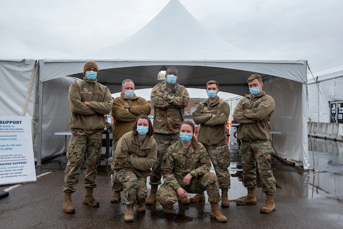 South Carolina, poses for a photo with his team at the American Disabilities Accessibility tent at the Community Vaccination Center (CVC) at the Minnesota State Fairgrounds in St. Paul, Minnesota, April 23, 2021. The CVC welcomes St. Paul community members to receive free COVID-19 vaccines. U.S. Northern Command, through U.S. Army North, remains committed to providing continued, flexible Department of Defense support to the Federal Emergency Management Agency as part of the whole-of-government response to COVID-19. (U.S. Air Force photo by Staff Sgt. Mikaley Kline)