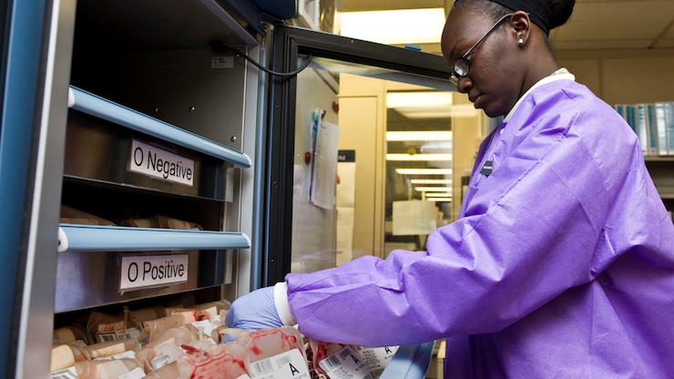 hospital worker sorting through blood donations