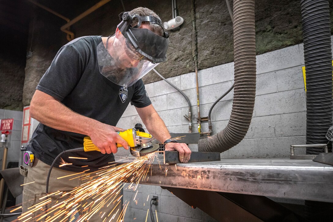 Tim Rice, Shop 17 Sheet Metal mechanic, preps the foundation for a storage box March 19, 2020, during his shift at Puget Sound Naval Shipyard & Intermediate Maintenance Facility in Bremerton, Washington. In his spare time, Rice and his dog Kimber volunteer for Kitsap County Search & Rescue. (PSNS & IMF photo by Scott Hansen)