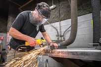 Tim Rice, Shop 17 Sheet Metal mechanic, preps the foundation for a storage box March 19, 2020, during his shift at Puget Sound Naval Shipyard & Intermediate Maintenance Facility in Bremerton, Washington. In his spare time, Rice and his dog Kimber volunteer for Kitsap County Search & Rescue. (PSNS & IMF photo by Scott Hansen)