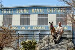 Tim Rice poses with his dog Kimber, a two-year-old Belgian Malinois, outside Puget Sound Naval Shipyard & Intermediate Maintenance Facility in Bremerton, Washington, where he works as a Shop 17 Sheet Metal mechanic. In their spare time, Rice and Kimber volunteer for Kitsap County Search & Rescue. (PSNS & IMF photo by Scott Hansen)
