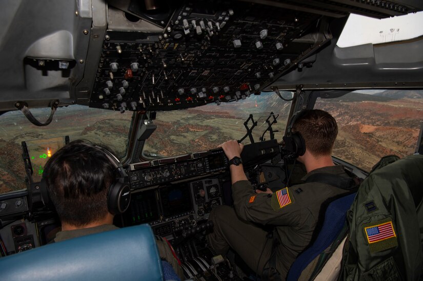 U.S. Air Force Capt. Tony Urbino, an aircraft commander from the 15th Airlift Squadron, and Capt. Ryan Sunderland, a co-pilot from the 16th Airlift Squadron, conduct a low level training flight over Montana, April 25, 2021.