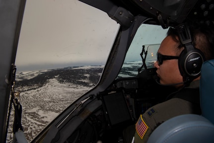 U.S. Air Force Capt. Tony Urbino, an aircraft commander from the 15th Airlift Squadron, and Capt. Ryan Sunderland, a co-pilot from the 16th Airlift Squadron, conduct a low level training flight over Montana, April 25, 2021.