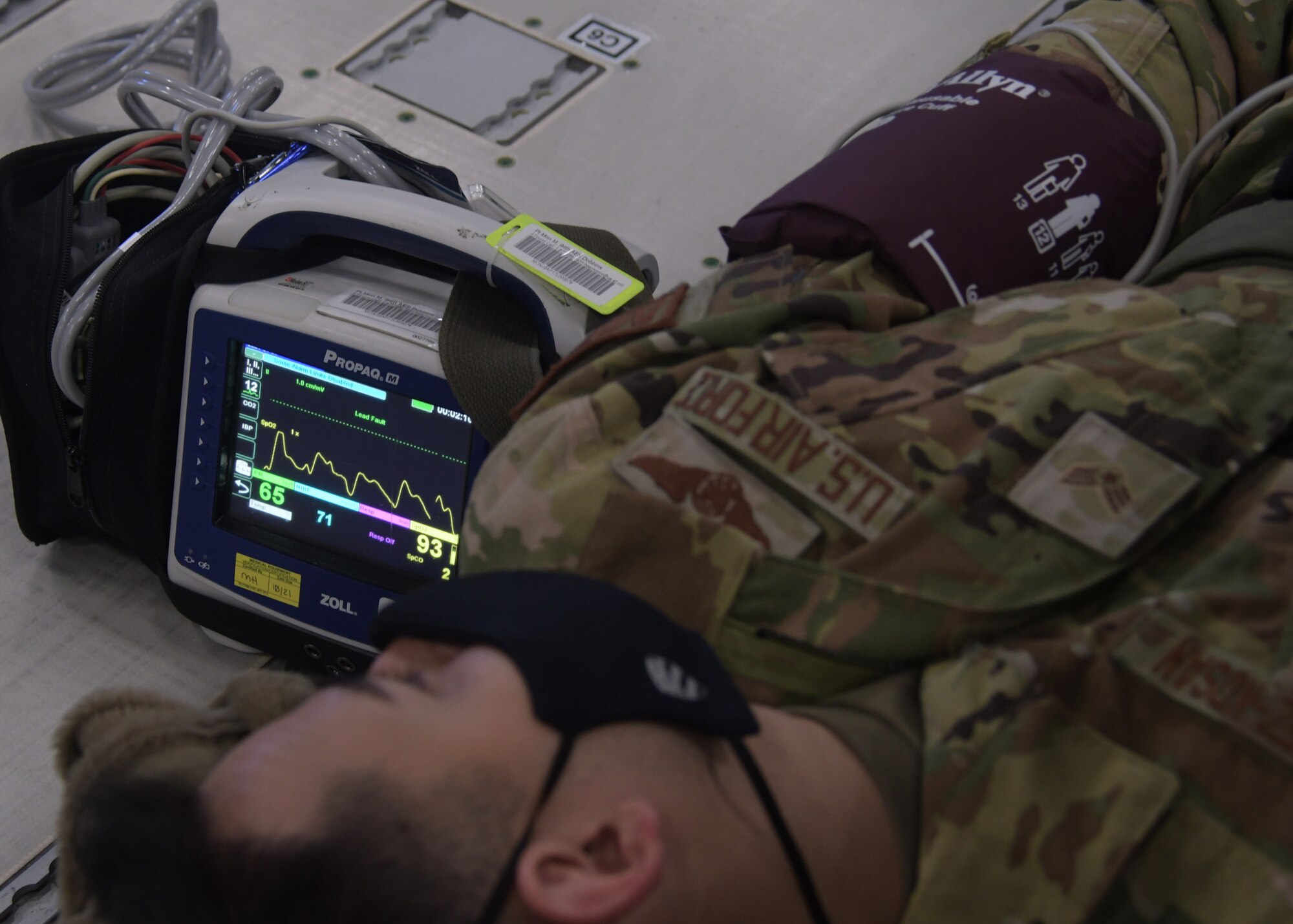 A simulated patient has his blood pressure checked during a training flight on a new KC-46A Pegasus from the 916th Air Refueling Wing, flown by the 77th Air Refueling Squadron, on April 23rd, 2021. During the flight, aeromedical evacuation Airmen from across the Air Force Reserve trained by participating in in-air medical emergencies. (U.S. Air Force photo by Tech. Sgt. Miles Wilson)