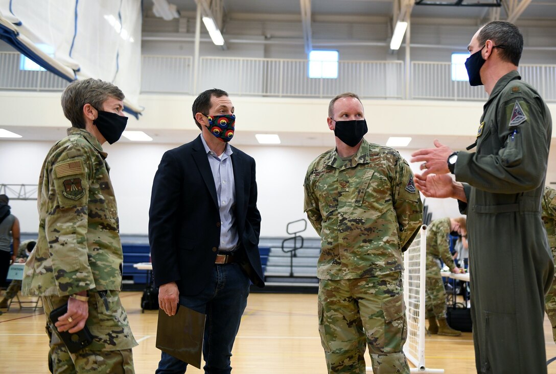 From right to left, Maj. Gregory Trifilo, 460th Operational Readiness Squadron chief of Aerospace Medicine and public health emergency officer, speaks to Col. Brian Chellgren, acting Buckley Garrison commander, Congressman Jason Crow, and Col. Shannon Phares, 460th Medical Group commander, about the vaccine point of dispensing (POD) located on Buckley Air Force Base, Colo., April 29, 2021. Crow visited Buckley to see first-hand how the 460th Medical Group operates the vaccine POD lines, which allow the Air Force to provide mass vaccinations to the beneficiaries or target population. (U.S. Space Force photo by Airman 1st Class Haley N. Blevins)