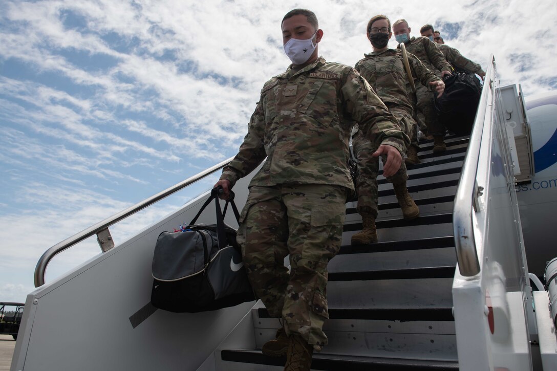Airmen disembark an aircraft