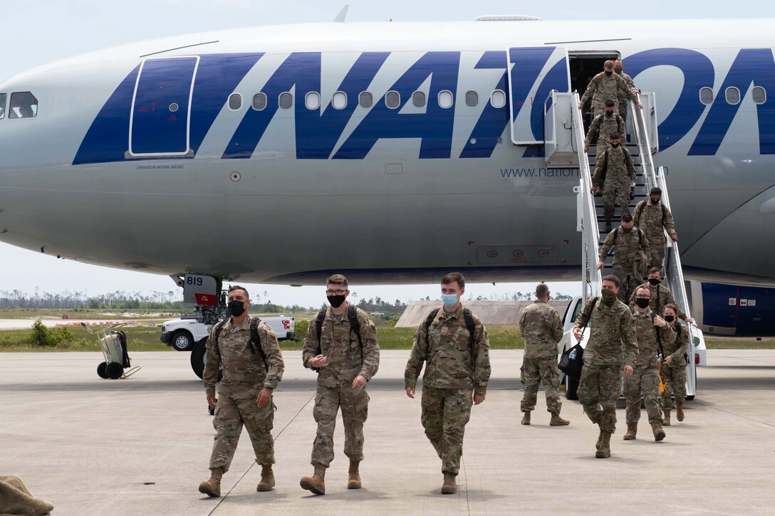 Airmen disembark an aircraft