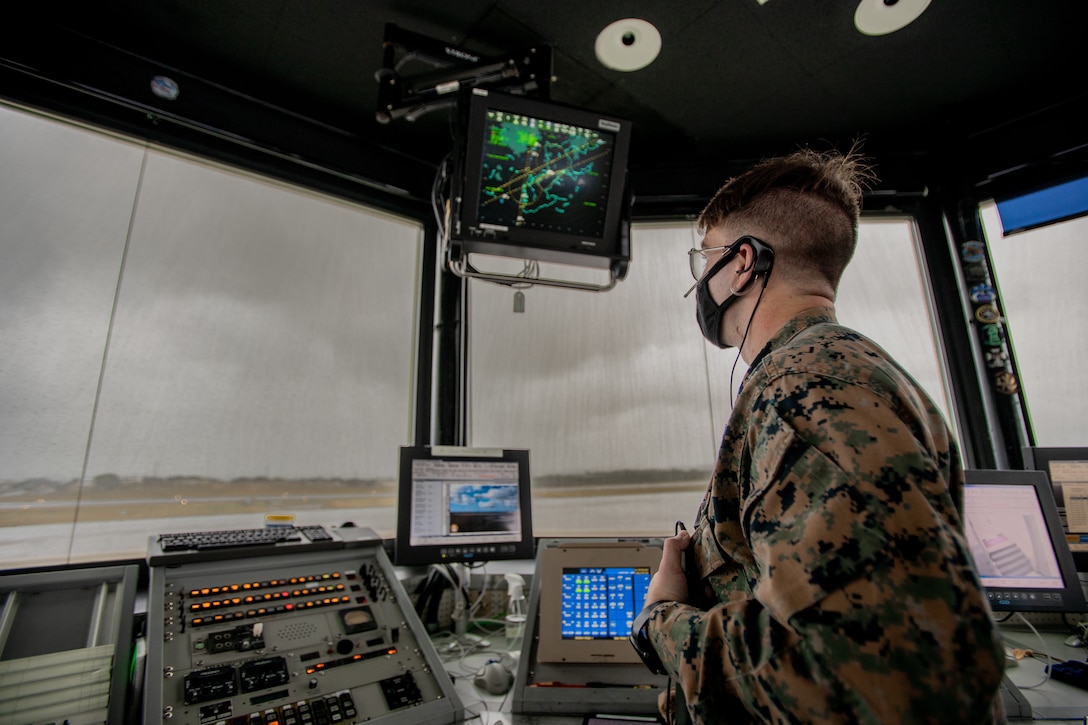 U.S. Marine Corps Lance Cpl. Collin Walton, an air traffic control specialist with Headquarters and Headquarters Squadron, Marine Corps Air Station Futenma, communicates with aircraft on MCAS Futenma, Okinawa, Japan, Jan. 7, 2021. Air traffic controllers aboard MCAS Futenma are responsible for the safe and expeditious flow of air traffic as well as the security of the mission of aviation assets. (U.S. Marine Corps photo by Cpl. Terry Wong)