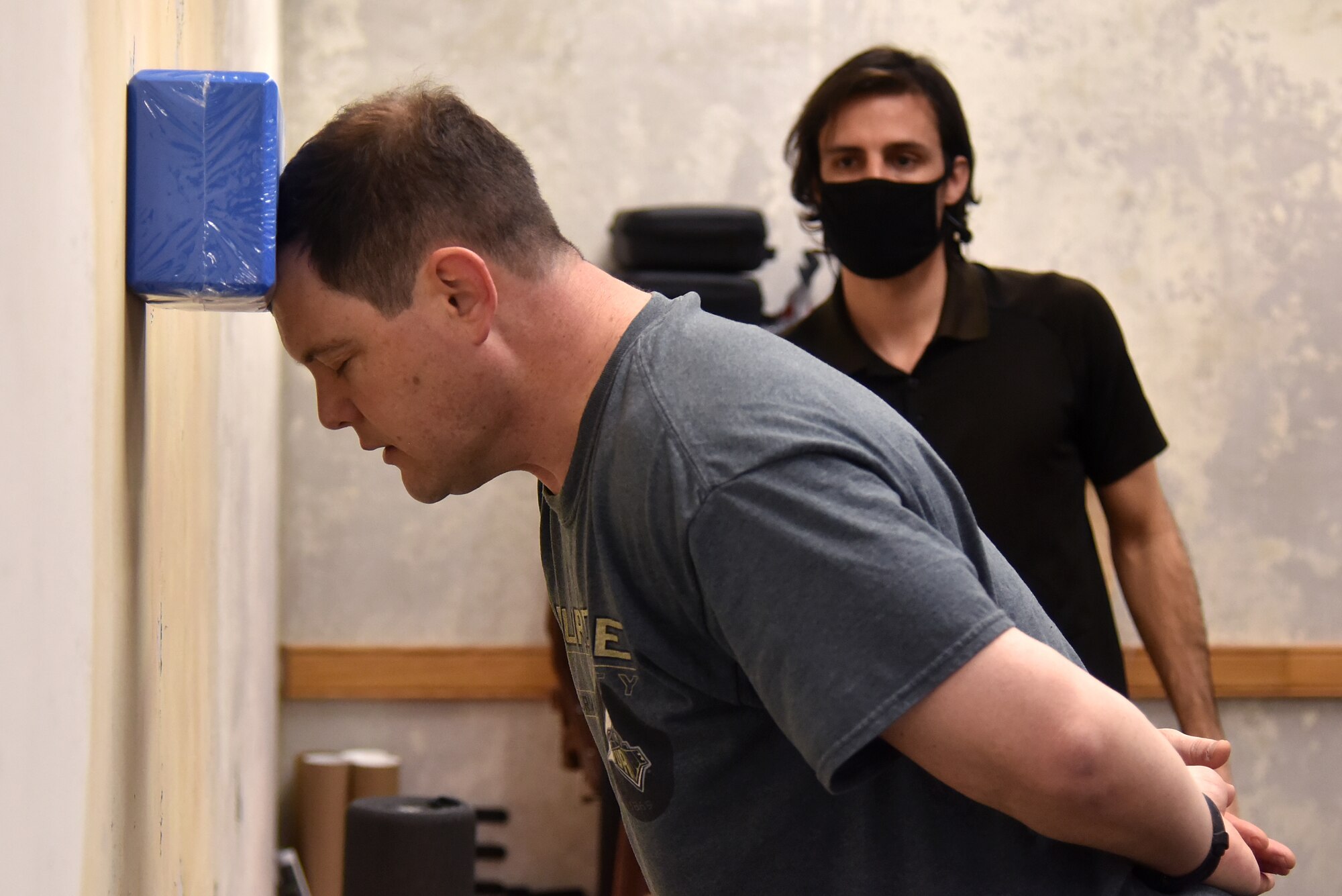 Lt. Col. Dustin “Chaos” Hudson, 8th Fighter Wing chief of safety, performs a neck exercise as Rodrigo Almada, 35th Fighter Squadron tactical athletic trainer, observes his form at Kunsan Air Base, Republic of Korea, April 5, 2021.  Almada works on strengthening pilot’s necks and working on their core to make it easier for them to accomplish the flying mission. (U.S. Air Force photo by Senior Airman Suzie Plotnikov)