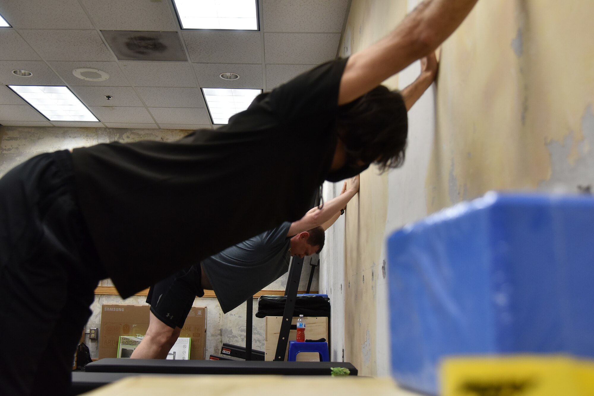Rodrigo Almada, 35th Fighter Squadron tactical athletic trainer, stretches with Lt. Col. Dustin “Chaos” Hudson, 8th Fighter Wing chief of safety, at Kunsan Air Base, Republic of Korea, April 5, 2021. The 8th Operations Group incorporated athletic trainers and a licensed massage therapist within the 35th and 80th Fighter Squadrons as part of a program known as ‘Optimizing the Human Weapon System,’ or OHWS. The program was created to reduce the frequency and severity of neck and back injuries, reduce duty time lost, improve quality of life, enhance readiness, and support fighter aircrew retention. (U.S. Air Force photo by Senior Airman Suzie Plotnikov)