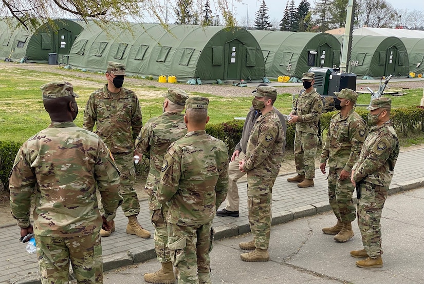 The 405th Army Field Support Brigade command team, Col. Brad Bane and Command Sgt. Maj. Kofie Primus, visited the Florida National Guard's 50th Regional Support Group in Powidz, Poland, April 29 to discuss the partnership that exists between the two units supporting thousands of Soldiers deployed to Poland with Base Operating Support-Integrator resources.