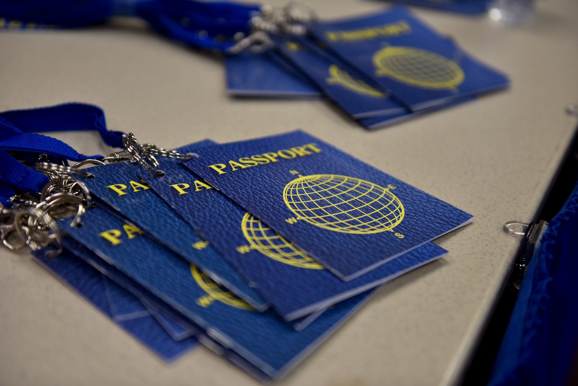 Passports line a table at the Around the World International Cultural Fair at Angelo State University in San Angelo, Texas, April 29, 2021. The passports were used by students as they toured booths displaying different items from various cultures. (U.S. Air Force photo by Staff Sgt. Seraiah Wolf)