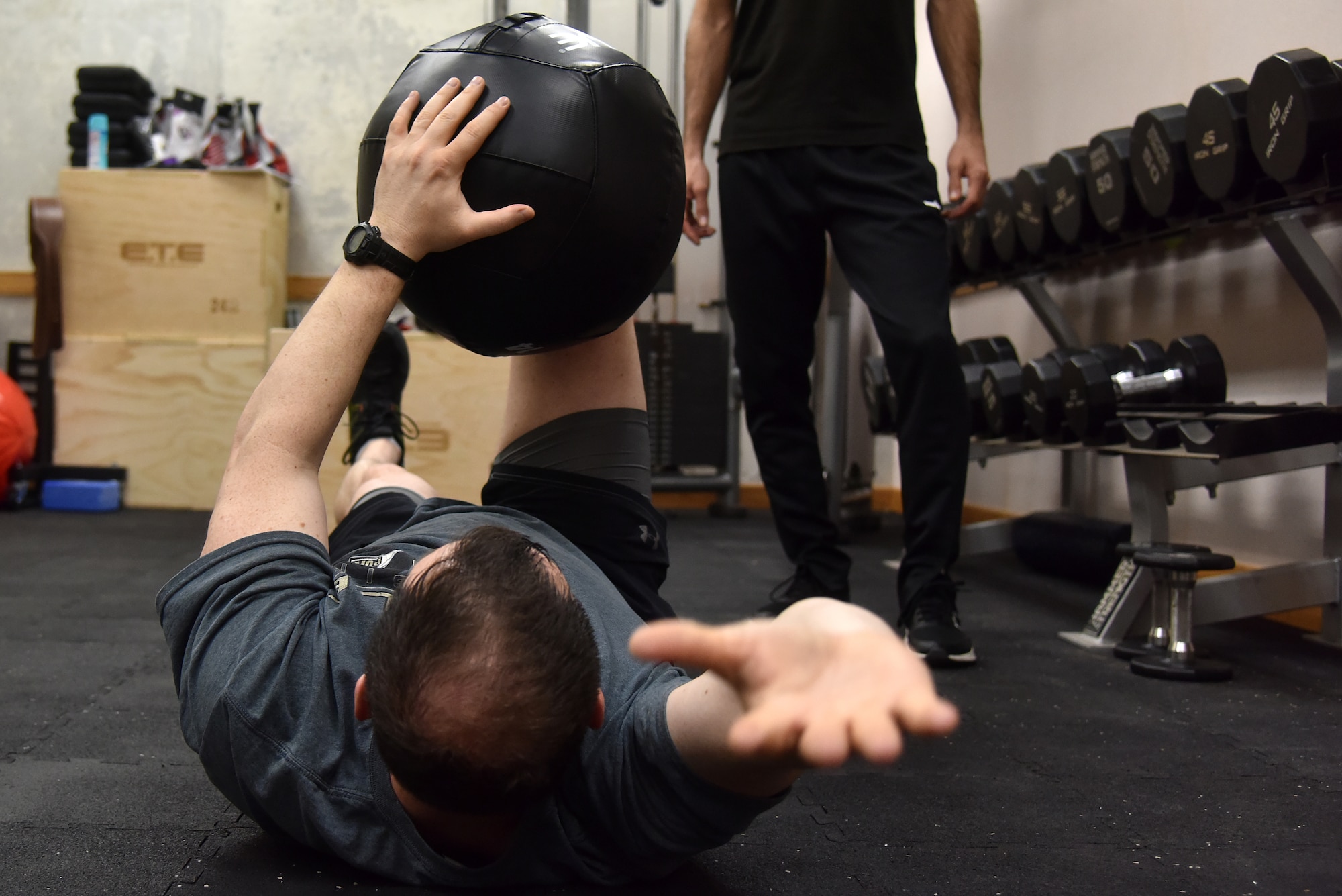 Lt. Col. Dustin “Chaos” Hudson, 8th Fighter Wing chief of safety, performs abdominal exercises monitored by Rodrigo Almada, 35th Fighter Squadron tactical athletic trainer, at Kunsan Air Base, Republic of Korea, April 5, 2021. Almada works on strengthening pilot’s necks and working on their core to make it easier for them to accomplish the flying mission. (U.S. Air Force photo by Senior Airman Suzie Plotnikov)