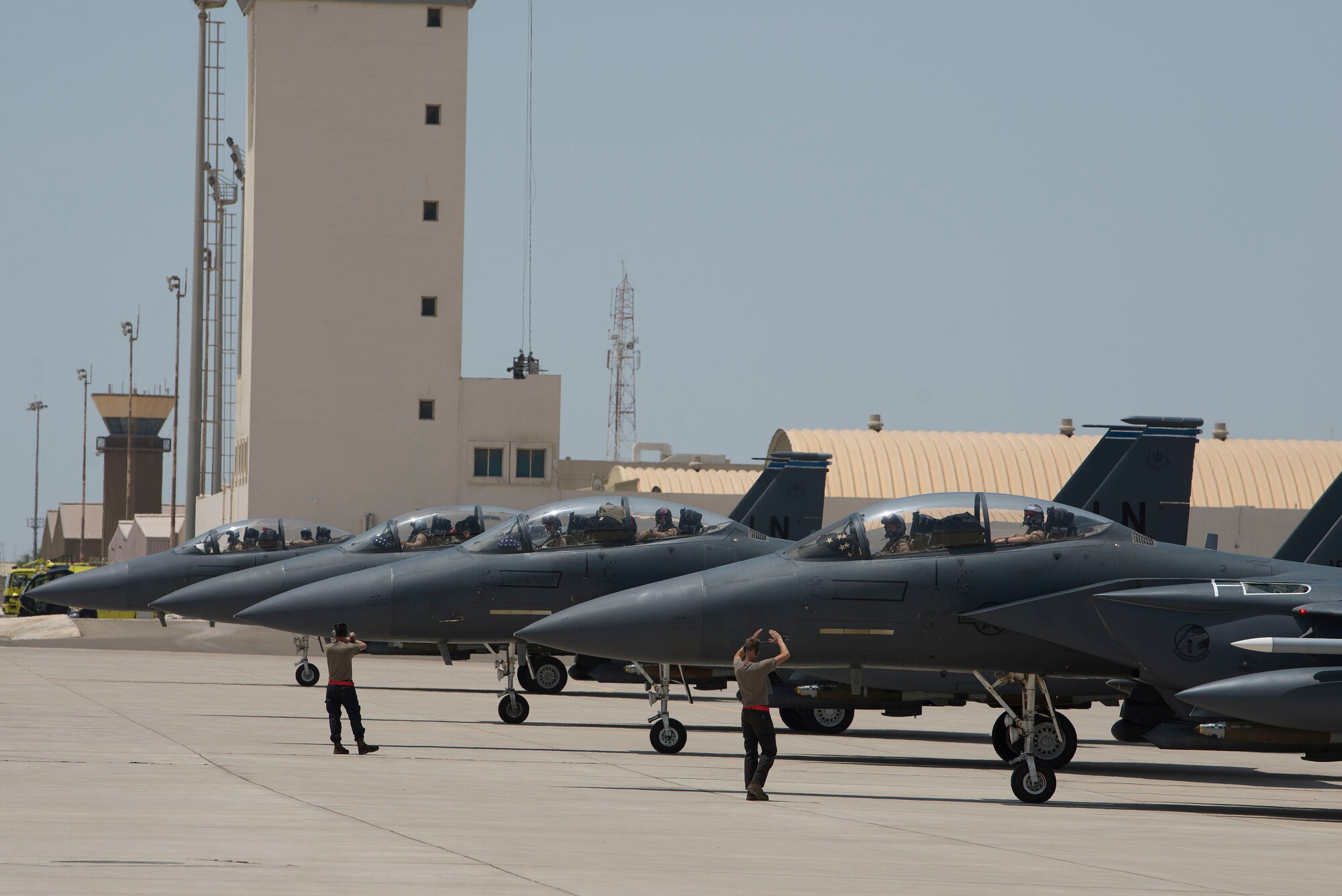 Four F-15E Strike Eagles assigned to the 494th Expeditionary Fighter Squadron (EFS) line up on the flightline at Al Dhafra Air Base, United Arab Emirates, April 25, 2021. Pilots and maintainers assigned to the 494th EFS, 332nd Air Expeditionary Wing executed the first combat tactical ferry mission as part of an Agile Combat Employment operation in a deployed theater. (U.S. Air Force photo by Staff Sgt. Zade Vadnais)