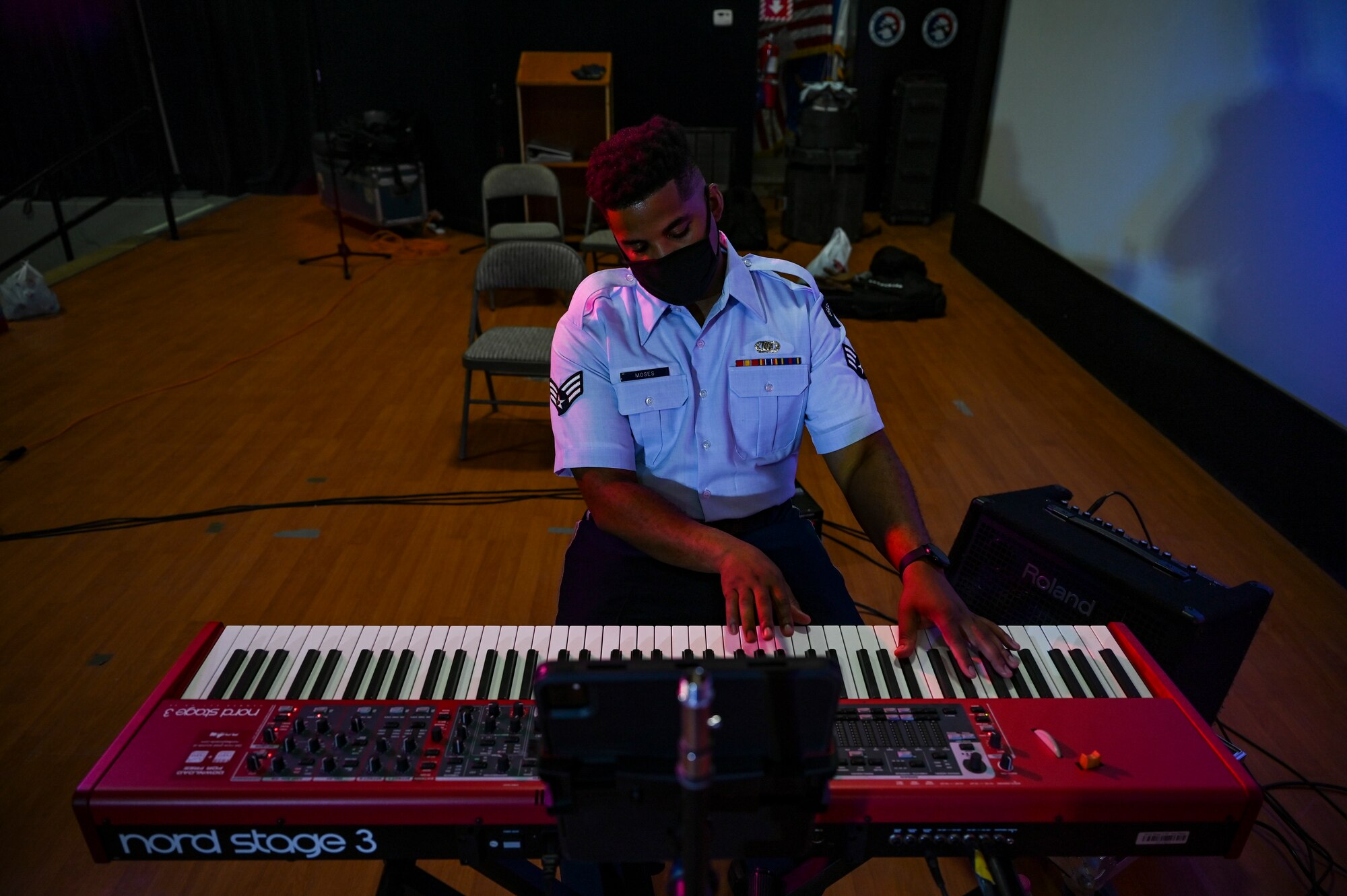Senior Airman Ryan Moses, a keyboardist assigned to the AFCENT Band, plays keyboard during an online concert for more than 50 students from the American International School located in Kuwait, April 25, 2021. The purpose of the concert was to introduce the students to American music, culture, and the AFCENT Band. (U.S. Air Force photo by Senior Airman Taylor Crul)