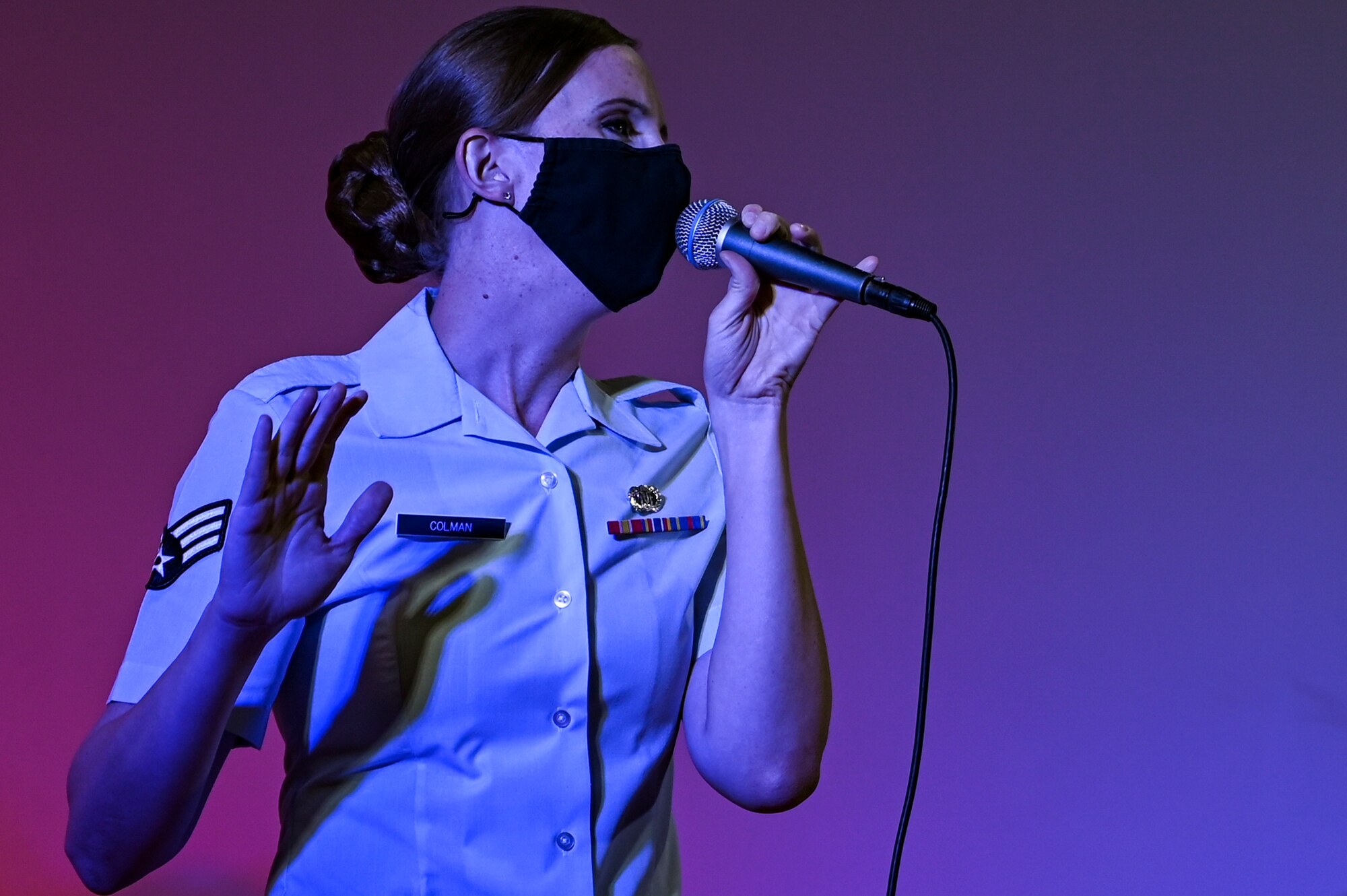 Senior Airman Rachel Colman, a vocalist assigned to the U.S. Air Forces Central Band, sings during an online concert for more than 50 students from the American International School located in Kuwait, at Al Udeid Air Base, Qatar, April 25, 2021. The purpose of the concert was to introduce the students to American music, culture, and the AFCENT Band. (U.S. Air Force photo by Senior Airman Taylor Crul)