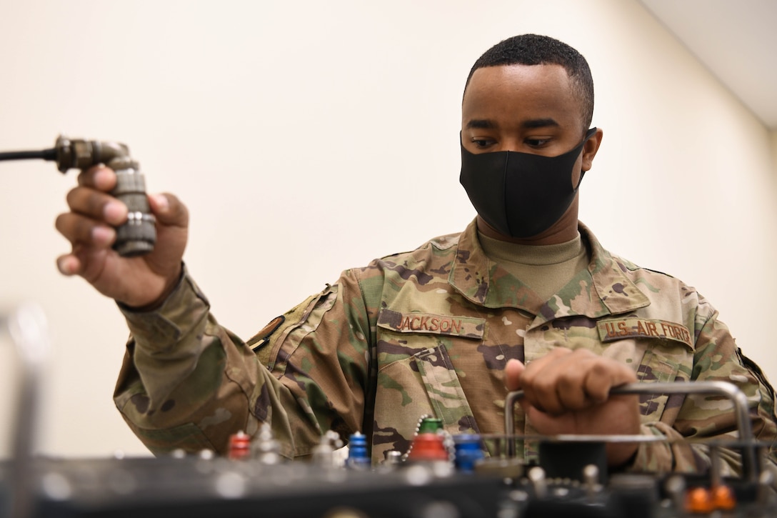 A precision measurement equipment laboratory technician from the 18th Component Maintenance Squadron calibrates a piece of equipment.