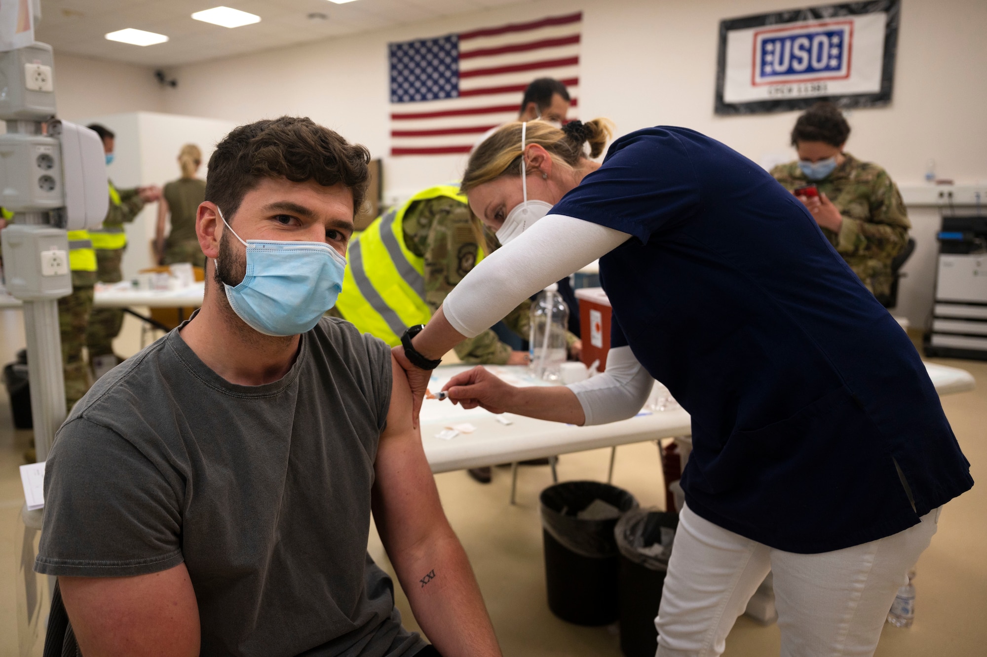 Benny Klein, 86th Civil Engineer Group accounting technician, receives a COVID-19 vaccine shot from Iris Geist, a German local national nurse, at Ramstein Air Base, Germany