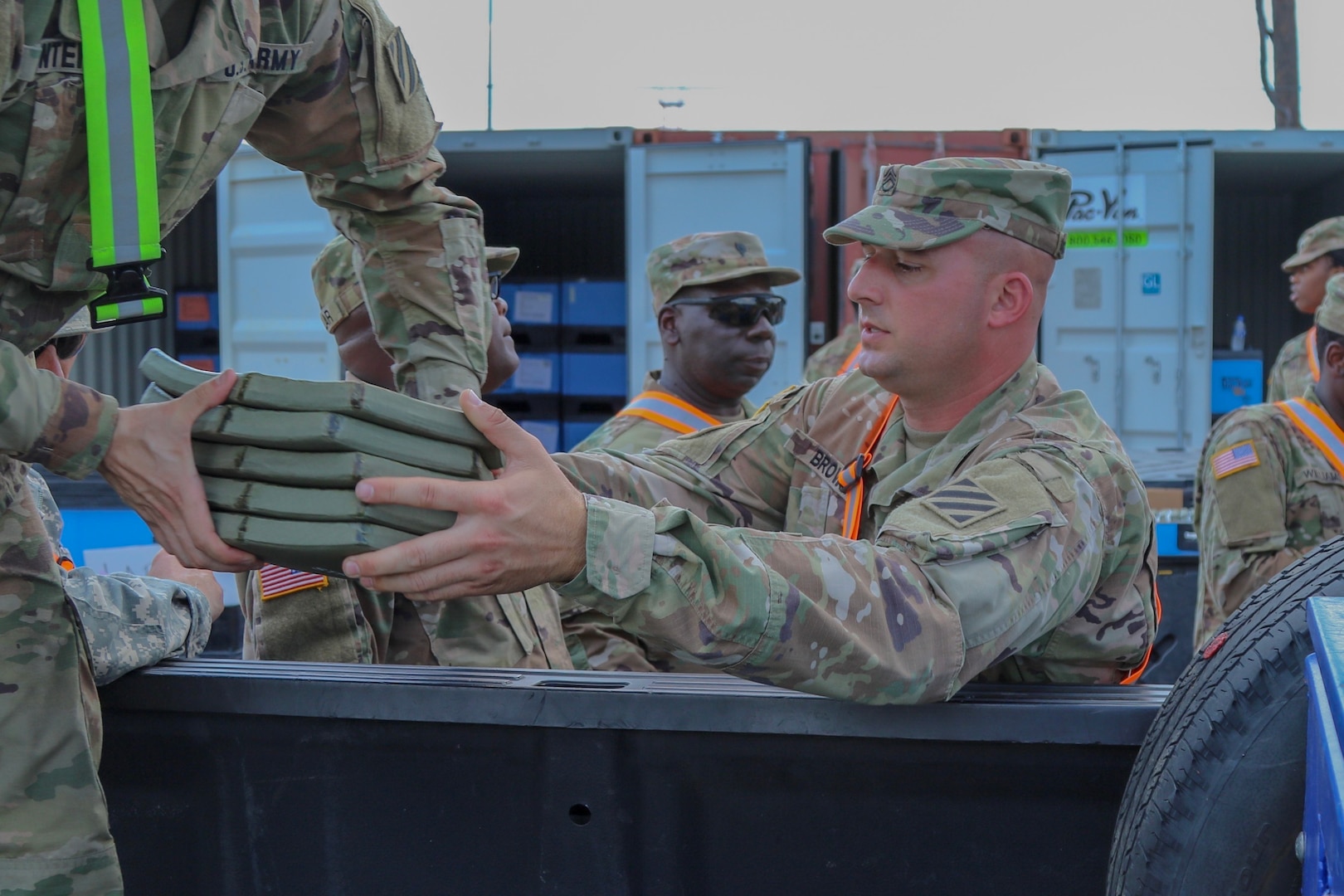 Fort Polk, La. - Georgia Army National Guardsman Staff Sgt. Shane Brown, supply sergeant, Delta Company, 2nd Battalion, 121 Infantry Regiment, Valdosta, Ga., hands over Enhanced Small Arms Protective Inserts for loading during the 48th Infantry Brigade Combat Team’s Joint Readiness Training Center rotation. The Troop Support Clothing and Textile Hard Body Armor Testing Team was recently awarded the Fall Innovation Award for successfully overcoming a COVID-19 related slowdown of testing of protective inserts.(Photo by Army National Guard Staff Sgt. R.J. Lannom)