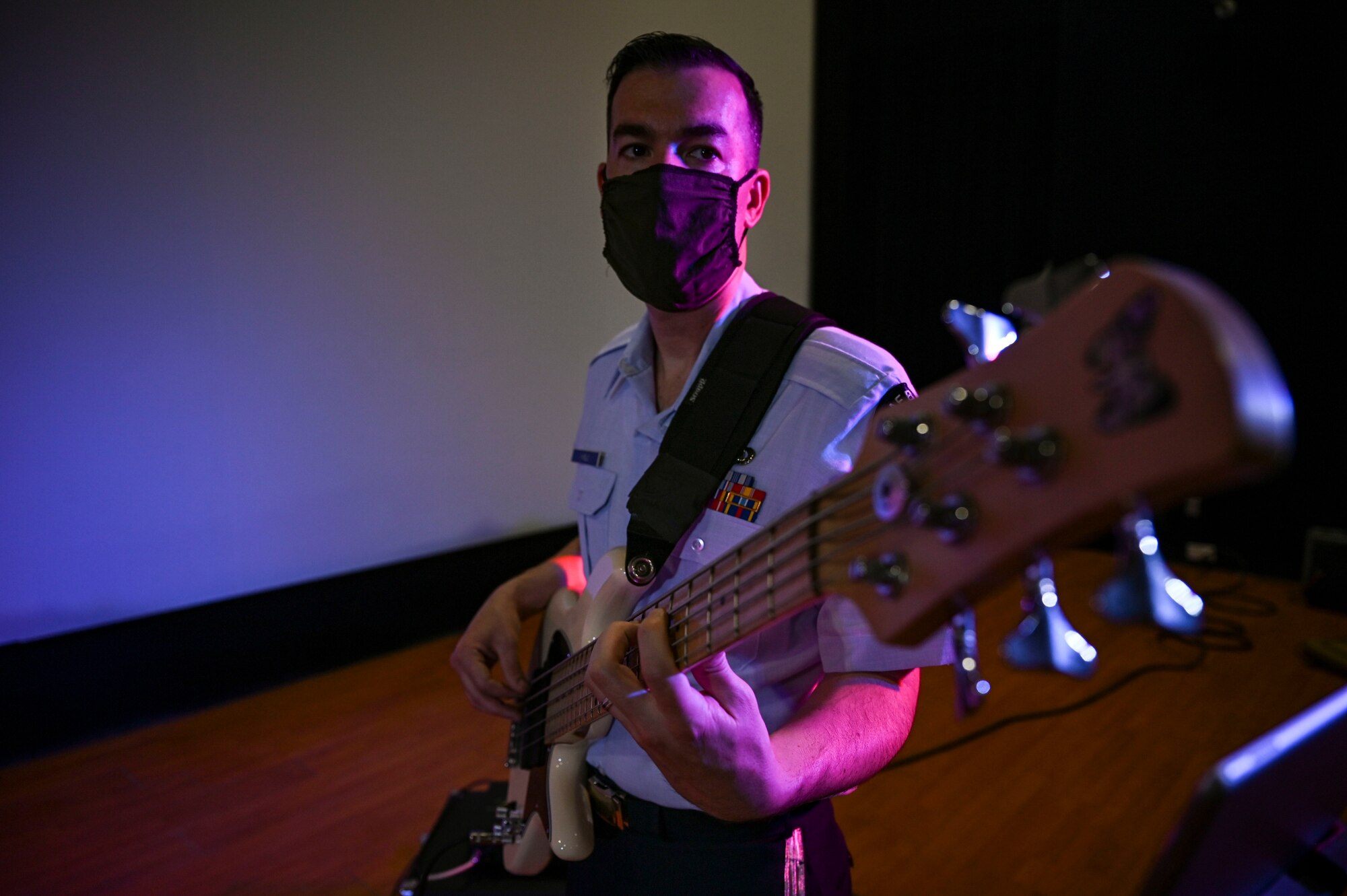 Tech. Sgt. Jordan Kimble, a bass guitarist assigned to the AFCENT Band, plays bass guitar during an online concert for more than 50 students from the American International School located in Kuwait, April 25, 2021. The purpose of the concert was to introduce the students to American music, culture, and the AFCENT Band. (U.S. Air Force photo by Senior Airman Taylor Crul)