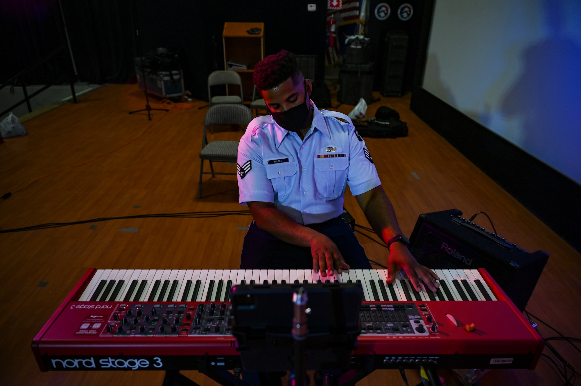 Senior Airman Ryan Moses, a keyboardist assigned to the AFCENT Band, plays keyboard during an online concert for more than 50 students from the American International School located in Kuwait, April 25, 2021. The purpose of the concert was to introduce the students to American music, culture, and the AFCENT Band. (U.S. Air Force photo by Senior Airman Taylor Crul)