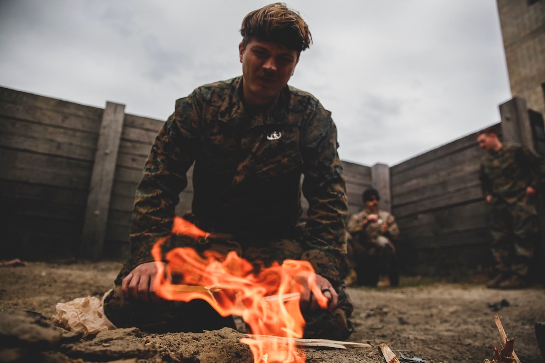 A Marine with the 24th Marine Expeditionary Unit builds a fire for an ammunition burn during an urban demolition exercise at Koth Demolition Range in Rota, Spain, April 24, 2021. 24th MEU, embarked with the Iwo Jima Amphibious Ready Group, is forward-deployed in the U.S. Sixth Fleet area of operations in support of U.S. national security interests in Europe and Africa.