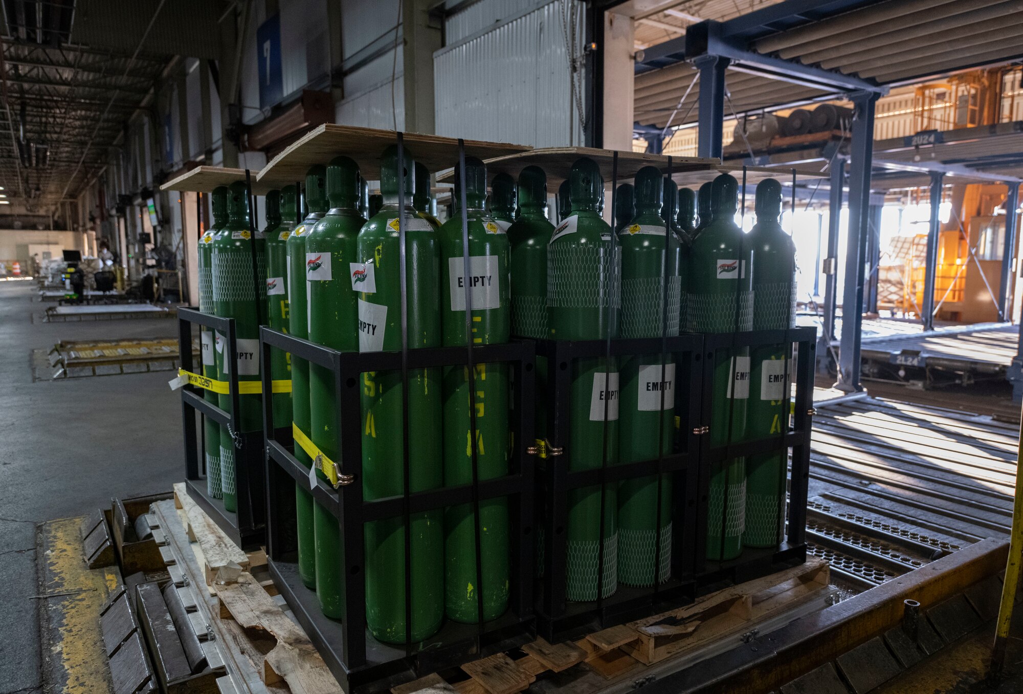 A pallet full of oxygen cylinders.