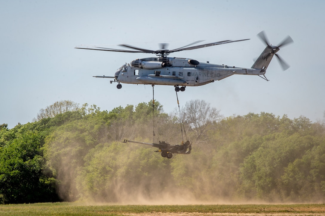 A U.S. Marine Corps CH-53E Super Stallion with Marine Heavy Helicopter Squadron 464, 2nd Marine Aircraft Wing, sling loads a M777 Howitzer in support of an artillery raid as part of Exercise Rolling Thunder 21.2 at Camp Lejeune, N.C., April 28, 2021.