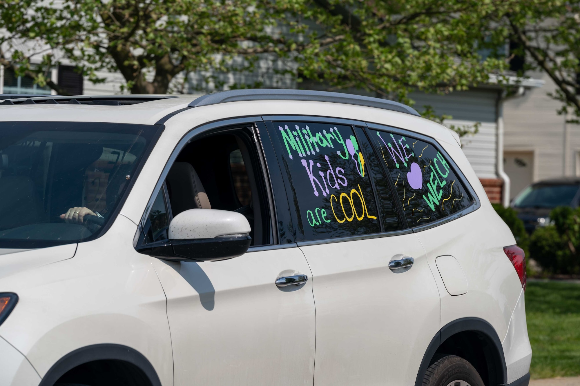 A faculty member from George S. Welch Elementary School drives her decorated vehicle through housing on Dover Air Force Base, Delaware, as part of the Month of the Military Child parade April 28, 2021. Teachers and faculty from Welch as well as Dover AFB Middle School drove through base housing in celebration of the military children who attend the schools. (U.S. Air Force photo by Airman 1st Class Faith Schaefer)