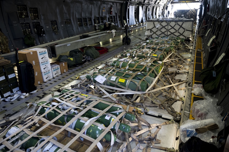 Oxygen tanks and other COVID-19 supplies sit in a C-5M Super Galaxy at Travis Air Force Base, Calif., April 28, 2021. The United States government, through the U.S. Agency for International Development, donated medical supplies to assist the country of India in its ongoing fight against COVID-19. The aid includes 440 oxygen cylinders and regulators, 1 million N95 masks and 1 million COVID-19 rapid diagnostic kits. (U.S. Air Force photo by Senior Airman Jonathon Carnell)