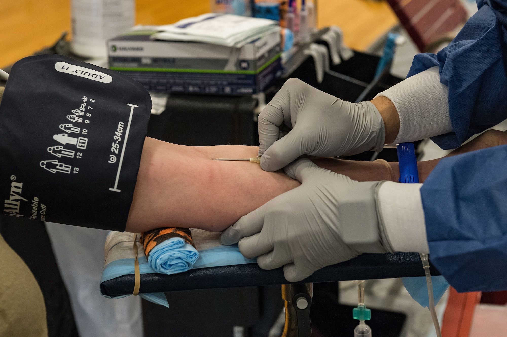 U.S. Navy Hospital Corpsman Second Class Eric Jo, Armed Services Blood Program Center medical laboratory technician, inserts a needle into the vein of Senior Airman Ashley Lowe, 436th Operational Medical Readiness Squadron public health technician, at the fitness center on Dover Air Force Base, Delaware, April 29, 2021. Lowe and other Team Dover members donated blood during the Armed Services Blood Program blood drive. (U.S. Air Force photo by Roland Balik)