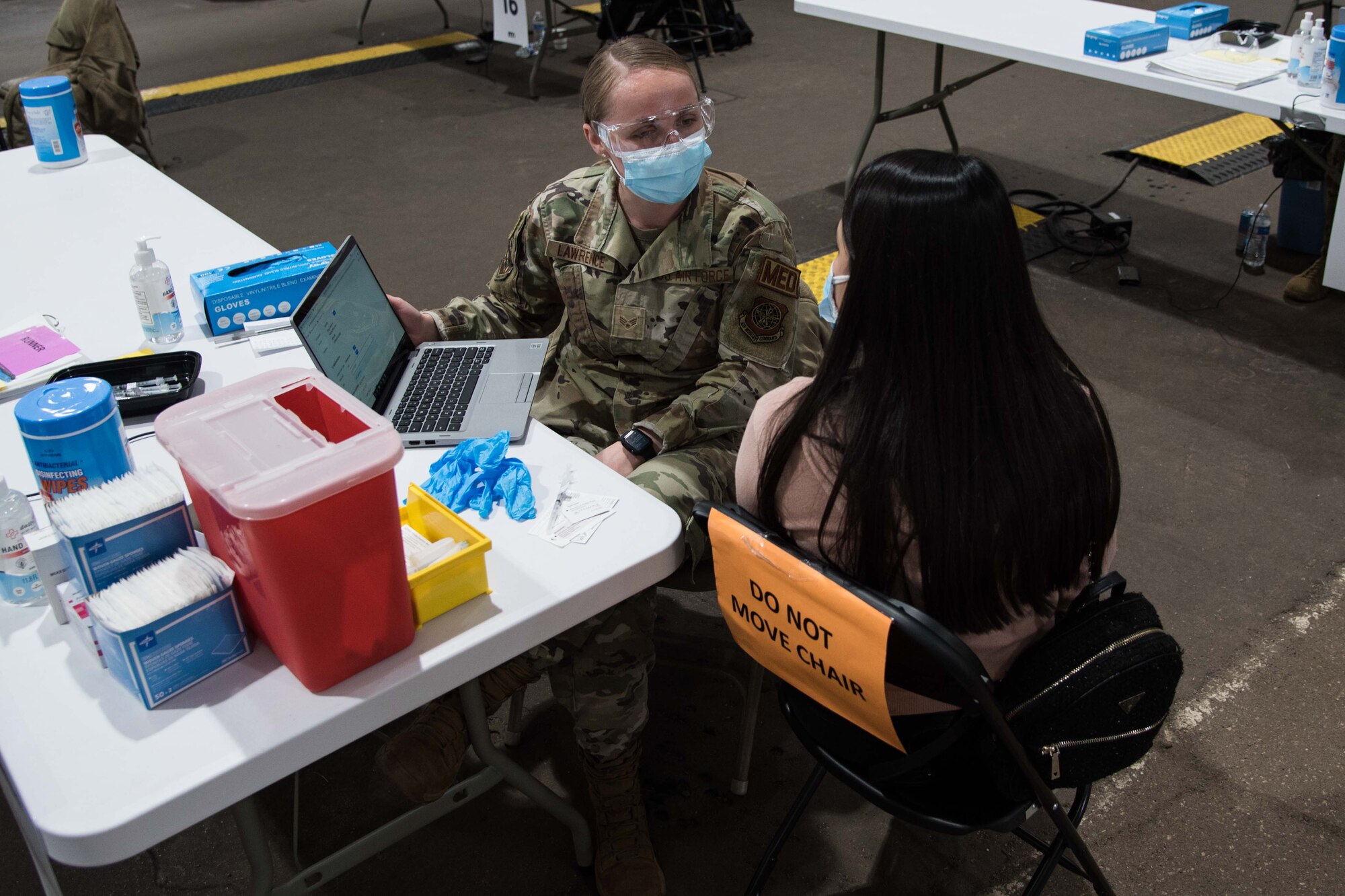 U.S. Air Force Senior Airman Daschia Lawrence, 92nd Healthcare Operation Squadron medical technician, prepares a patient for their COVID-19 vaccine April 27, 2021, at the Community Vaccination Center (CVC) in St. Paul, Minnesota. U.S. Northern Command, through U.S. Army North, remains committed to providing continued Department of Defense support to the Federal Emergency Management Agency as part of the whole-of government response to COVID-19. (U.S. Air Force photo by Senior Airman Alexi Bosarge)