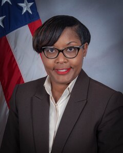 Dr. Angela Curtis, Deputy Director, DLA EEO portrait in front of a U.S. flag