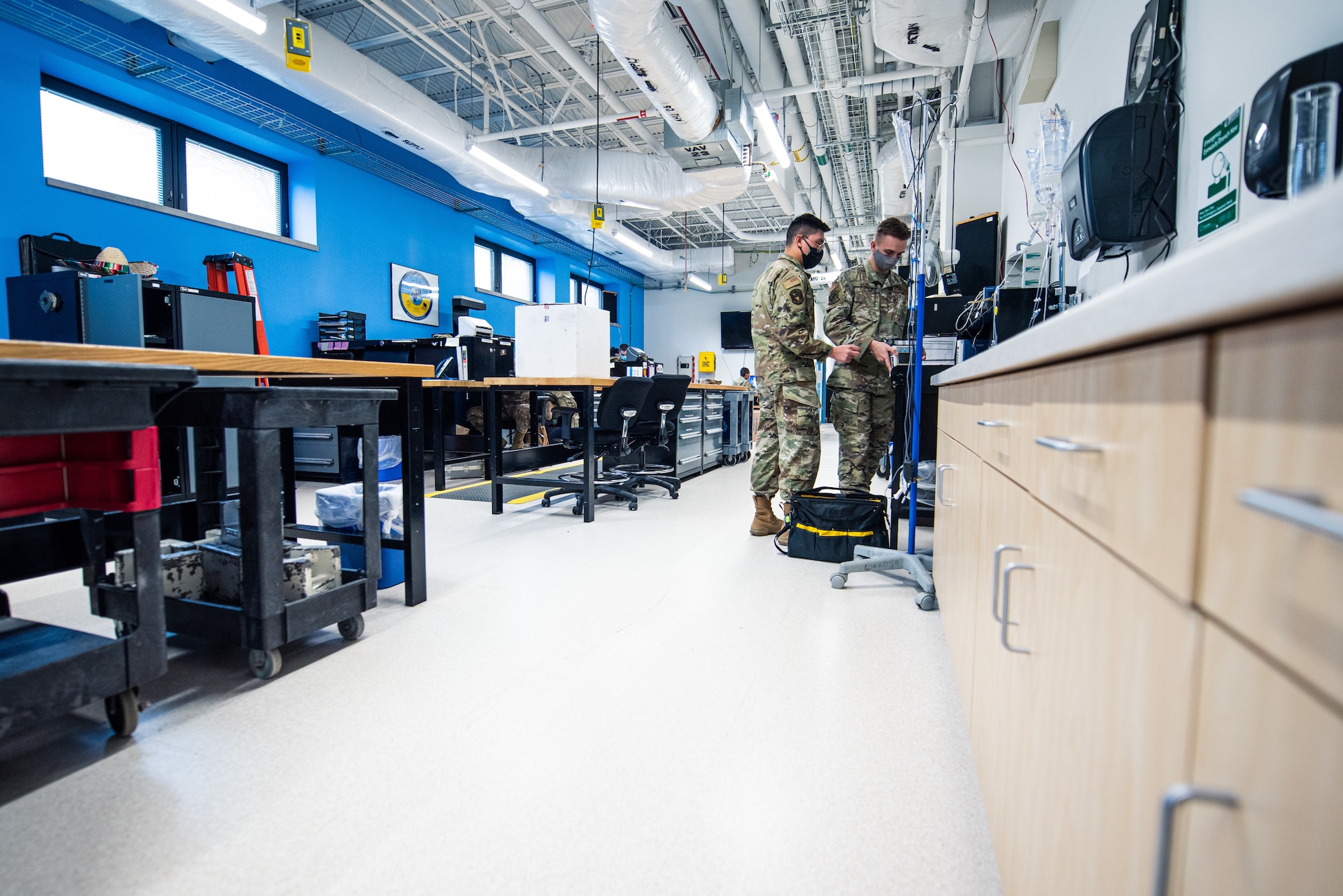 U.S. Air Force Airman 1st Class Eric Perez-Solano, 375th Medical Support Squadron biomedical equipment technician, and Airman 1st Class Sky Gauvin, 137th Aeromedical Evacuation Squadron biomedical equipment technician, repair medical equipment at Scott Air Force Base, Illinois, April 23, 2021. Biomedical equipment technicians to repair medical equipment and inspect to ensure the equipment is operating correctly. (U.S. Air Force photo by Airman 1st Class Isaac Olivera)