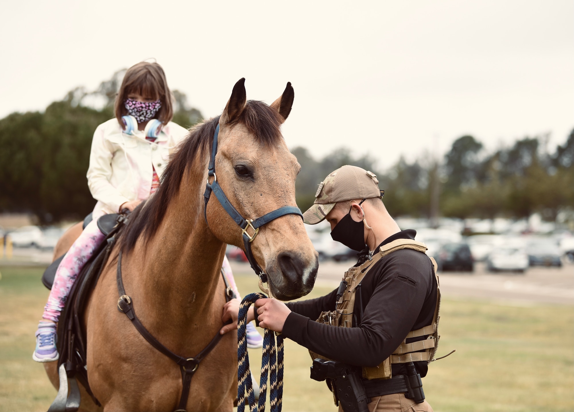 Visitors learn about the 30th Security Forces Squadron Military Working Horse unit during an Earth Day event on April 21, 2021, at Vandenberg Air Force Base, Calif. They use horses to monitor VAFB's 43 miles of coastline and 99,000 acres of hard-to-reach terrain. The Earth Day event also featured a raffle, a rock wall, food trucks, and vendors from local area earth-related agencies.  (U.S. Space Force photo by Senior Airman Hanah Abercrombie)