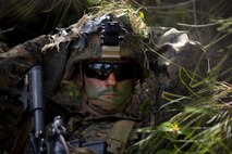 U.S. Marine Corps Cpl. Tyler Pearson, squad leader, Fox Company, 2nd Battalion, 8th Marine Regiment, takes a break from the sun and listens to the instructions for the steep incline repel event during the Advanced Infantry Course at Kahuku Training Area, Hawaii, April 22, 2021. This course is an experimental proof of concept with the intent of modernizing training and providing squad leaders with new capabilities. (U.S. Marine Corps photo by Lance Cpl. Terry Stennett III)