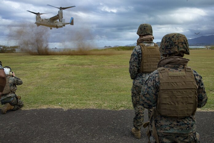 U.S. Marines attached to Headquarters Battalion, Marine Corps Base Hawaii, stand ready to board an MV-22B Osprey attached to Marine Medium Tiltrotor Squadron 268 after a final flight check. Marines participated in MV-22B Osprey familiarization training to promote resiliency, readiness, and unit cohesion. (U.S. Marine Corps photo by Cpl. Porfirio Gonzalez)