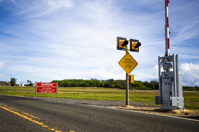 Signs are displayed warning drivers of aircraft activity on the flightline, Marine Corps Air Station Kaneohe Bay, Marine Corps Base Hawaii, April 28, 2021. MCAS Kaneohe Bay's flightline security measures are expected to increase throughout 2021. (U.S. Marine Corps photo by Lance Cpl. Brandon Aultman)