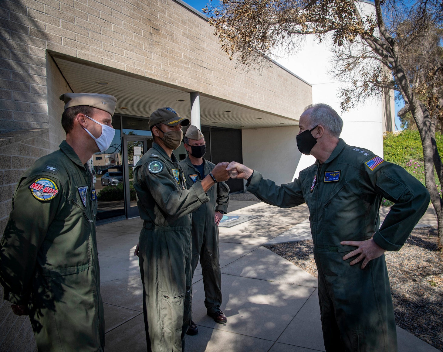 Vice Chief of Naval Operations (VCNO), Adm. Bill Lescher, is greeted by Capt. Dewon Chaney, commodore, Fleet Logistics Multi-Mission Wing (center), Capt. Jeffrey Melody, commodore, Helicopter Maritime Strike Wing Pacific (left), and Capt. Edward Weiler, deputy commodore, Helicopter Sea Combat Wing, U.S. Pacific Fleet (right) during a visit to Naval Air Station North Island (NASNI).